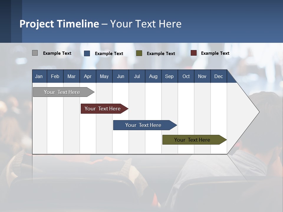 A Group Of People Sitting In Front Of A Stage PowerPoint Template