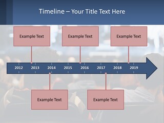 A Group Of People Sitting In Front Of A Stage PowerPoint Template