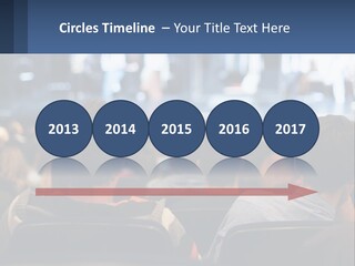 A Group Of People Sitting In Front Of A Stage PowerPoint Template