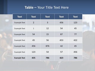 A Group Of People Sitting In Front Of A Stage PowerPoint Template