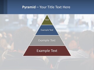 A Group Of People Sitting In Front Of A Stage PowerPoint Template