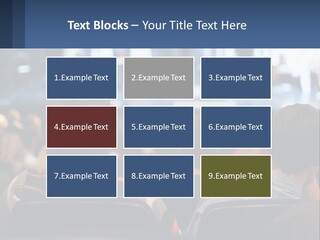 A Group Of People Sitting In Front Of A Stage PowerPoint Template