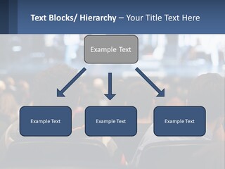 A Group Of People Sitting In Front Of A Stage PowerPoint Template