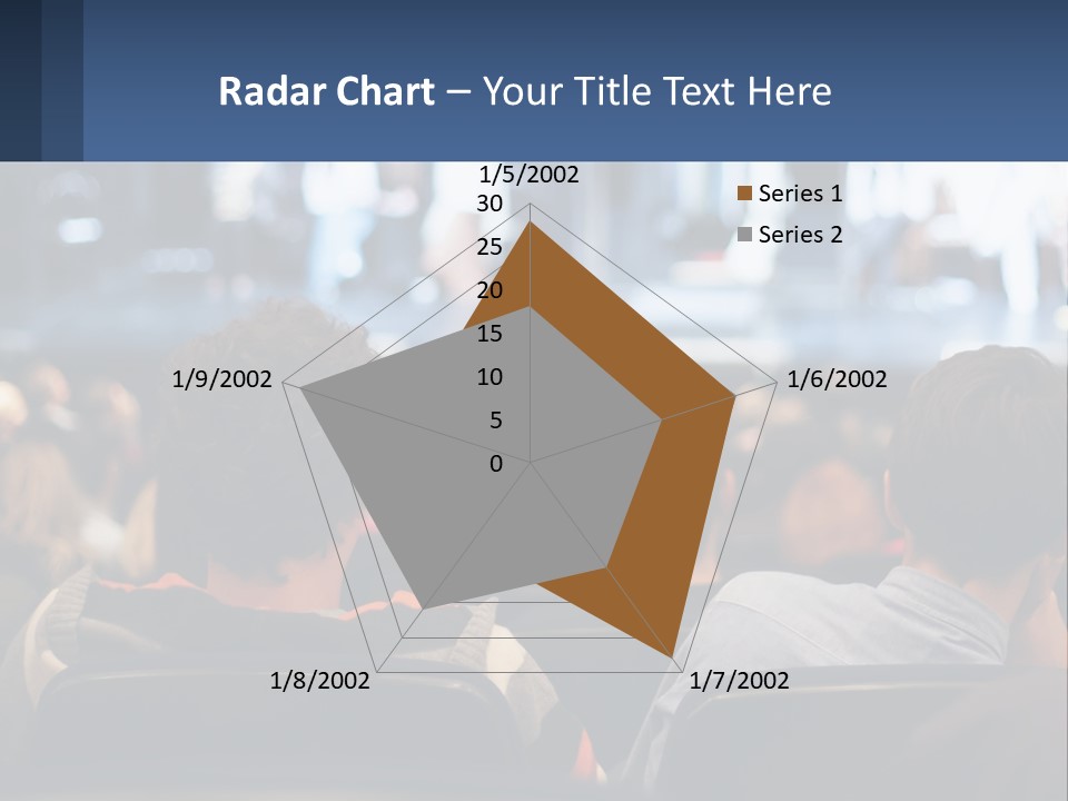 A Group Of People Sitting In Front Of A Stage PowerPoint Template