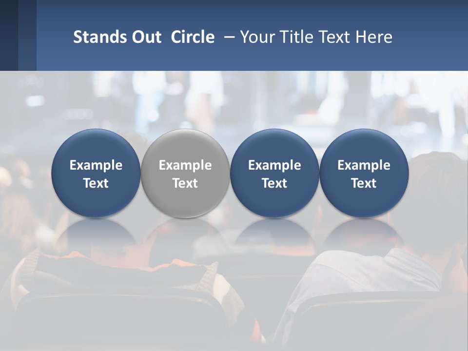 A Group Of People Sitting In Front Of A Stage PowerPoint Template