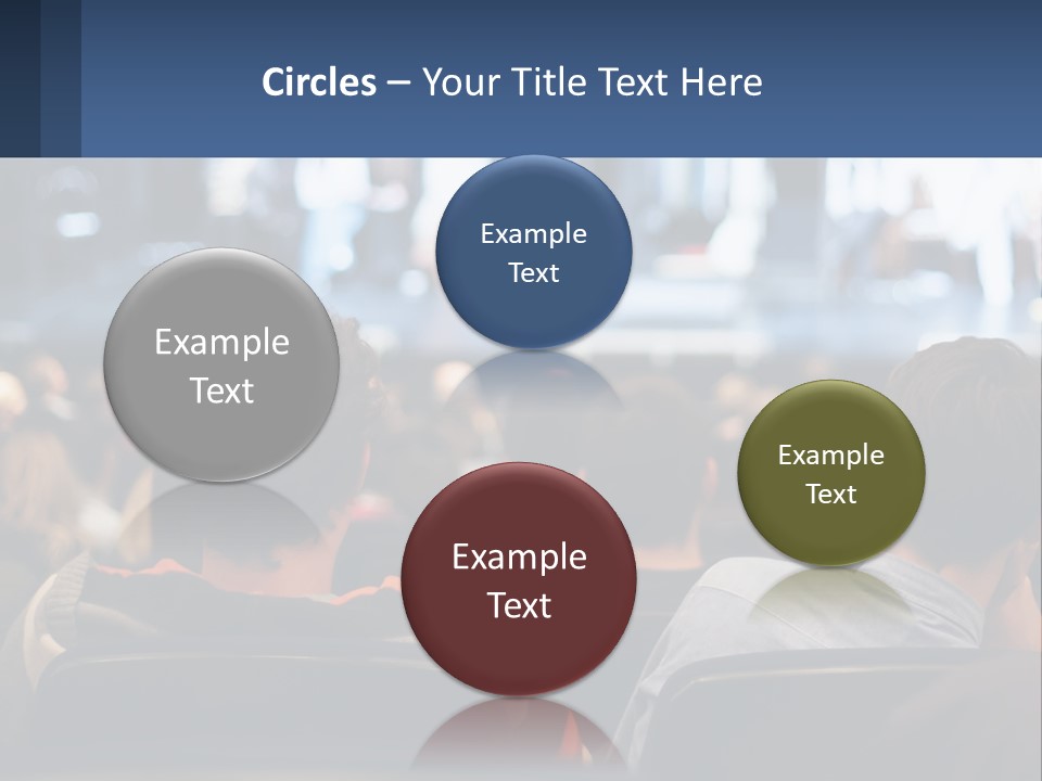 A Group Of People Sitting In Front Of A Stage PowerPoint Template