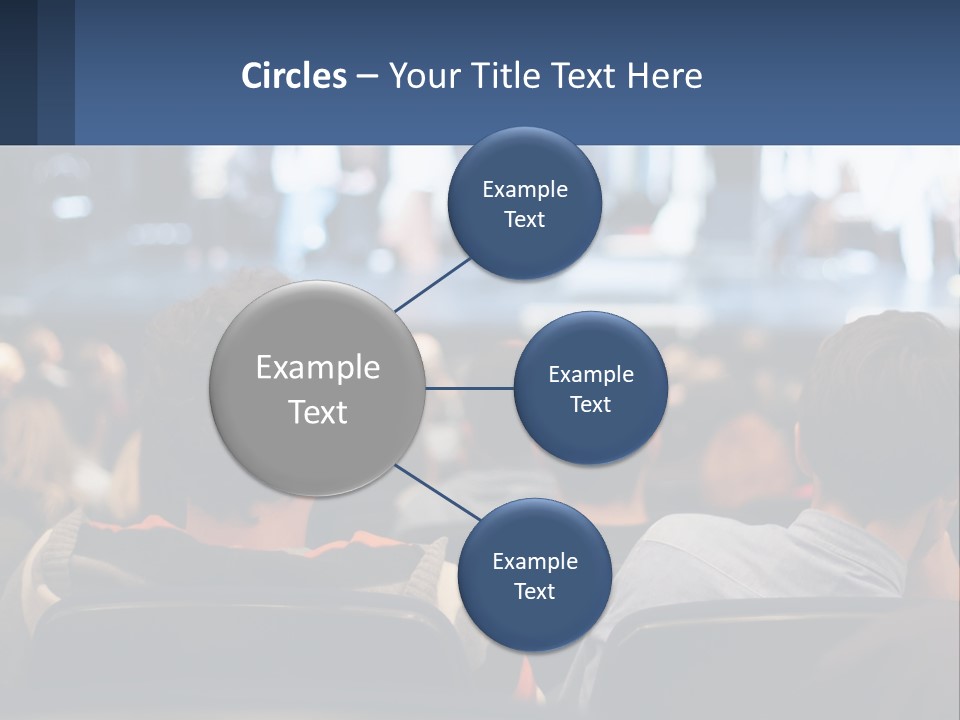 A Group Of People Sitting In Front Of A Stage PowerPoint Template