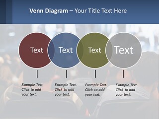 A Group Of People Sitting In Front Of A Stage PowerPoint Template