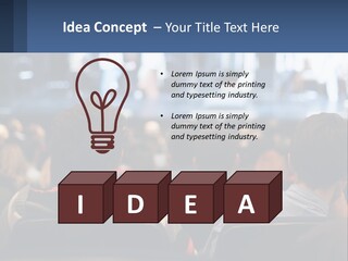 A Group Of People Sitting In Front Of A Stage PowerPoint Template