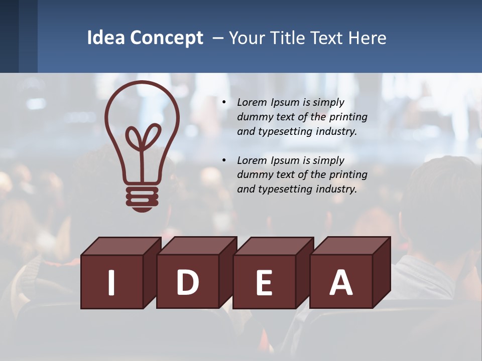 A Group Of People Sitting In Front Of A Stage PowerPoint Template