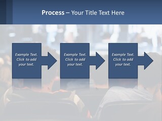 A Group Of People Sitting In Front Of A Stage PowerPoint Template