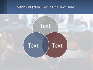 A Group Of People Sitting In Front Of A Stage PowerPoint Template