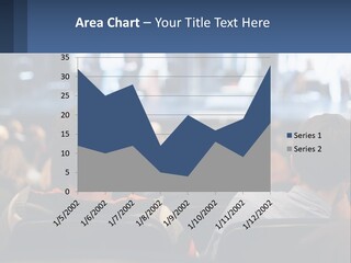A Group Of People Sitting In Front Of A Stage PowerPoint Template