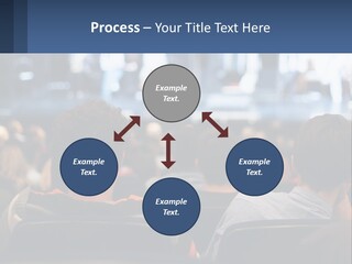 A Group Of People Sitting In Front Of A Stage PowerPoint Template