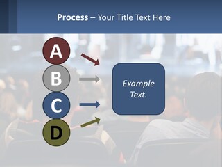 A Group Of People Sitting In Front Of A Stage PowerPoint Template