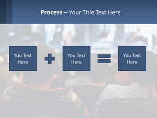 A Group Of People Sitting In Front Of A Stage PowerPoint Template