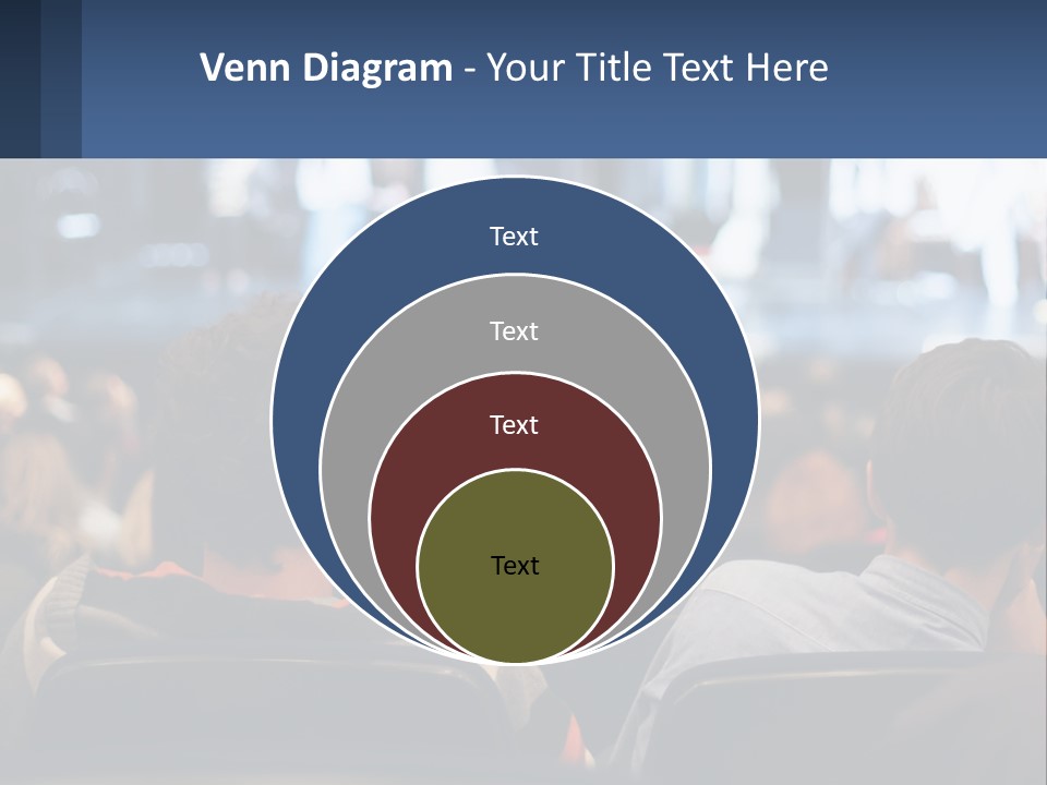 A Group Of People Sitting In Front Of A Stage PowerPoint Template