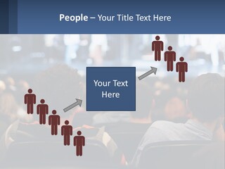 A Group Of People Sitting In Front Of A Stage PowerPoint Template