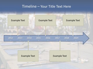 A Table Topped With Wine Glasses And Place Settings PowerPoint Template
