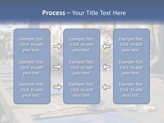 A Table Topped With Wine Glasses And Place Settings PowerPoint Template