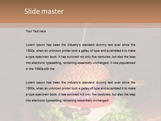A Hamburger With Lettuce, Tomato, Onion And Cheese On A Cutting Board PowerPoint Template