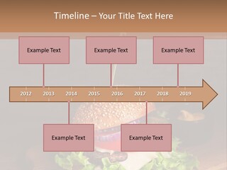 A Hamburger With Lettuce, Tomato, Onion And Cheese On A Cutting Board PowerPoint Template