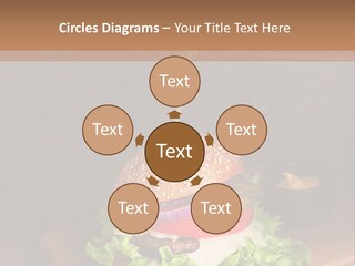 A Hamburger With Lettuce, Tomato, Onion And Cheese On A Cutting Board PowerPoint Template