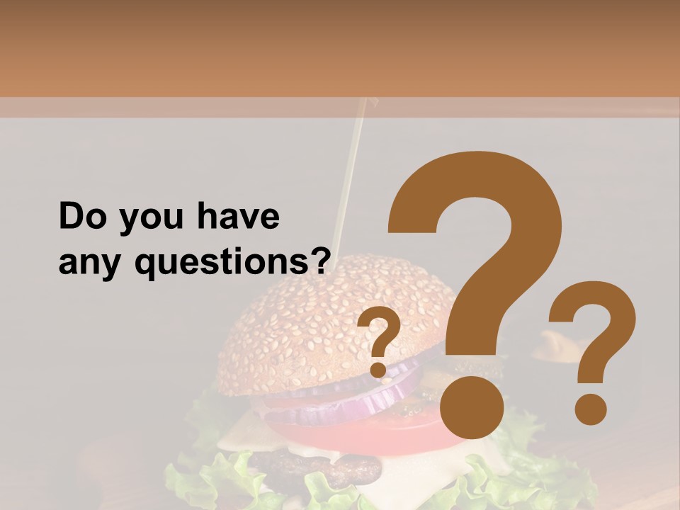 A Hamburger With Lettuce, Tomato, Onion And Cheese On A Cutting Board PowerPoint Template