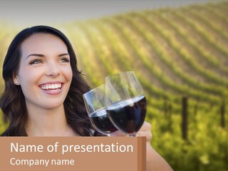 A Woman Holding A Glass Of Wine In Front Of A Vineyard PowerPoint Template