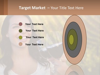 A Woman Holding A Glass Of Wine In Front Of A Vineyard PowerPoint Template