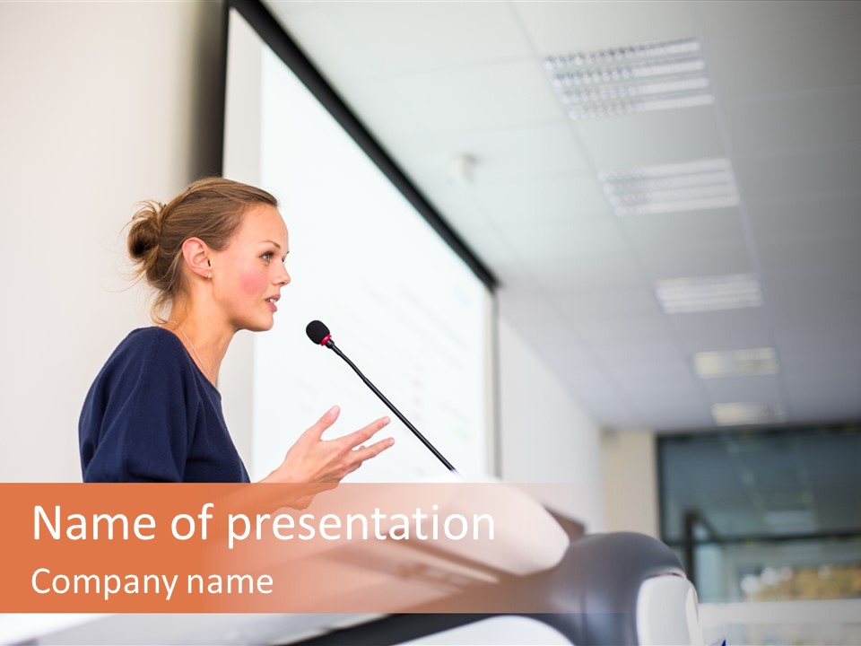 A Woman Speaking At A Podium With A Microphone PowerPoint Template
