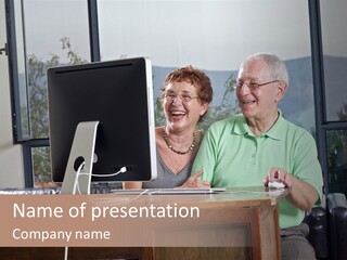 A Man And A Woman Sitting In Front Of A Computer PowerPoint Template