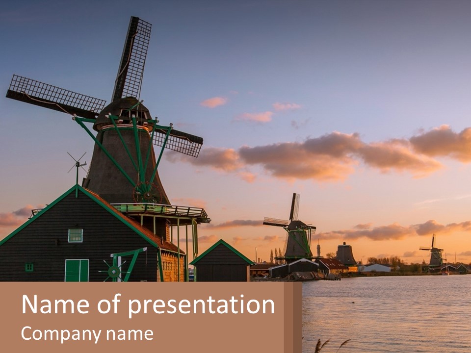 A Group Of Windmills Sitting Next To A Body Of Water PowerPoint Template