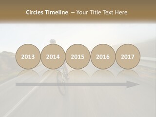 A Man Riding A Bike Down A Road PowerPoint Template