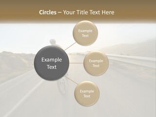 A Man Riding A Bike Down A Road PowerPoint Template