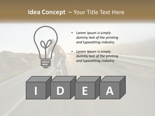 A Man Riding A Bike Down A Road PowerPoint Template