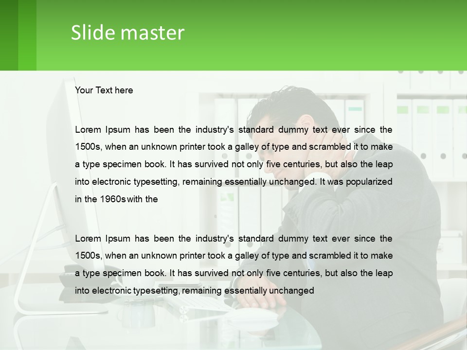 A Man Sitting At A Desk In Front Of A Computer PowerPoint Template