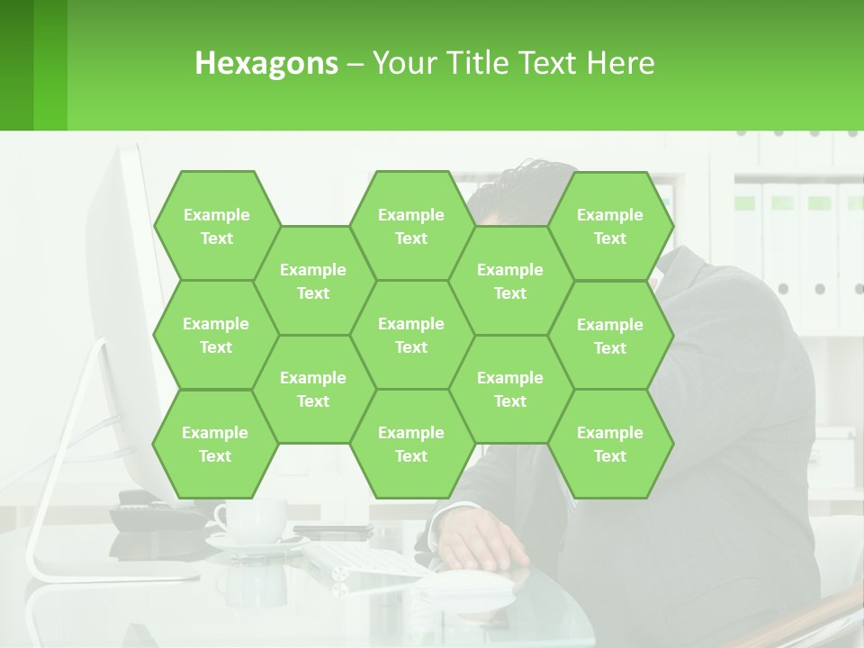 A Man Sitting At A Desk In Front Of A Computer PowerPoint Template