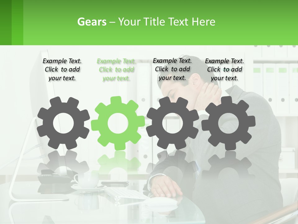 A Man Sitting At A Desk In Front Of A Computer PowerPoint Template