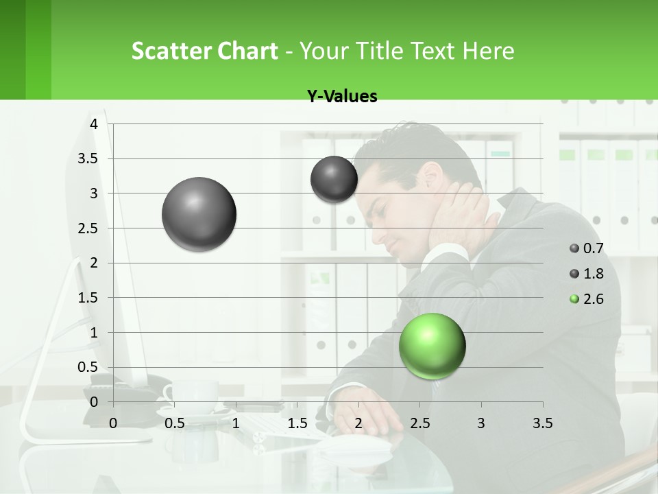A Man Sitting At A Desk In Front Of A Computer PowerPoint Template