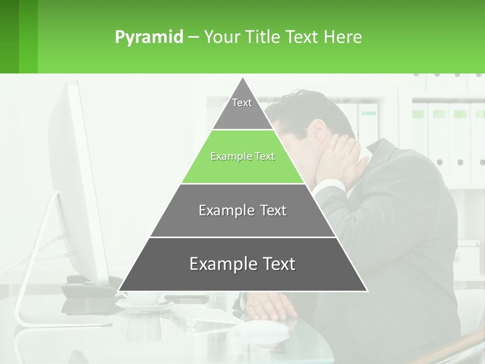 A Man Sitting At A Desk In Front Of A Computer PowerPoint Template