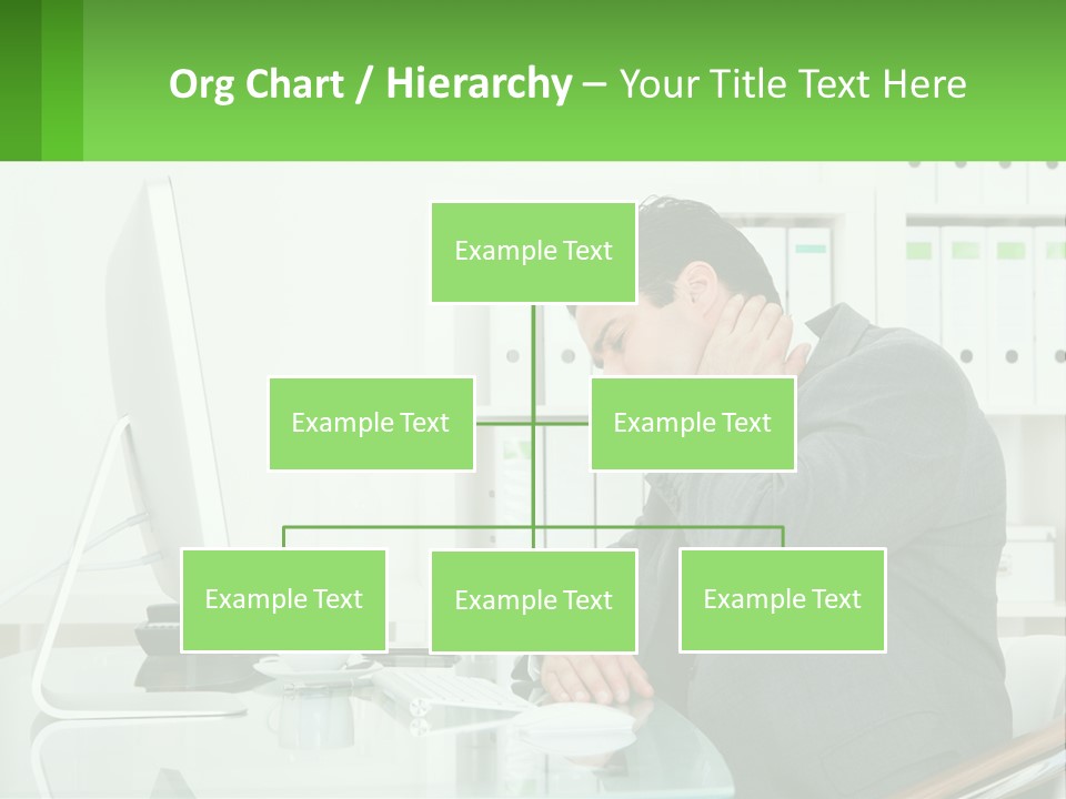 A Man Sitting At A Desk In Front Of A Computer PowerPoint Template
