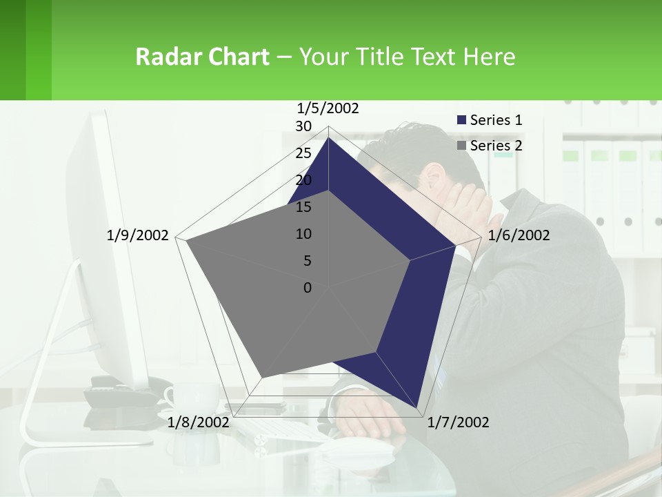 A Man Sitting At A Desk In Front Of A Computer PowerPoint Template