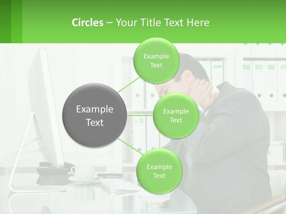 A Man Sitting At A Desk In Front Of A Computer PowerPoint Template