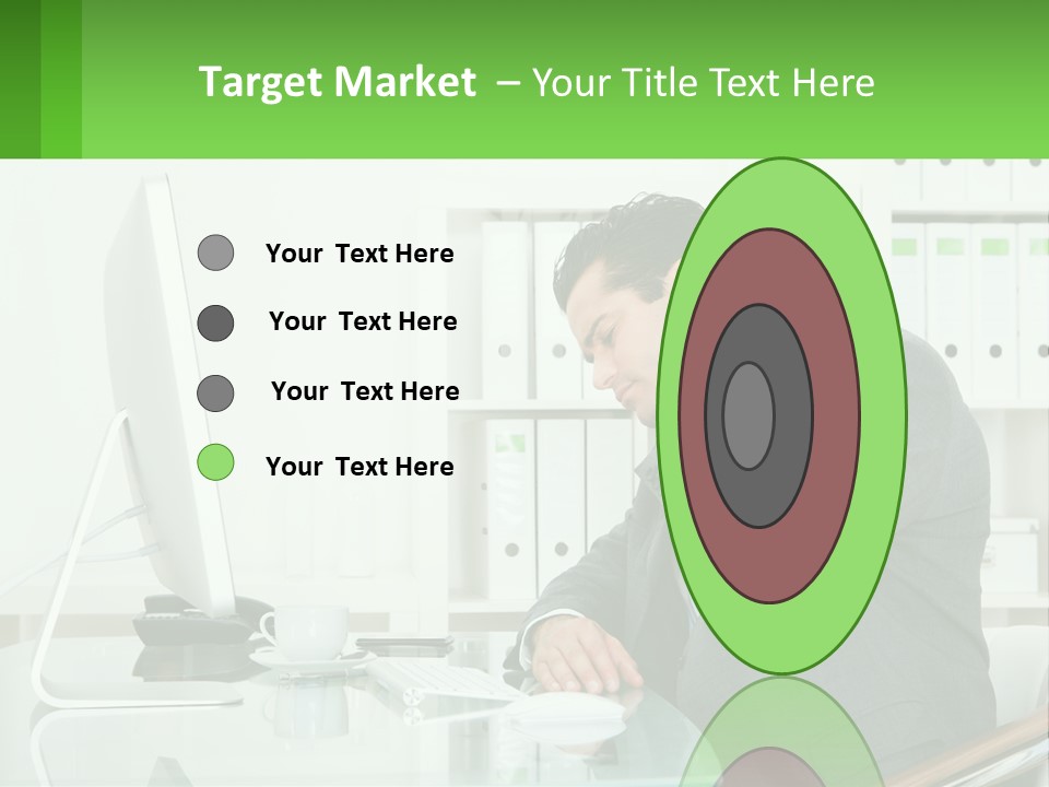 A Man Sitting At A Desk In Front Of A Computer PowerPoint Template