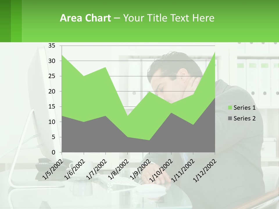 A Man Sitting At A Desk In Front Of A Computer PowerPoint Template