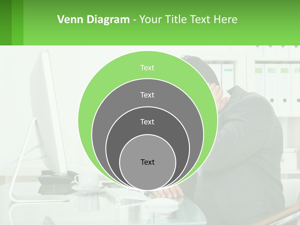 A Man Sitting At A Desk In Front Of A Computer PowerPoint Template