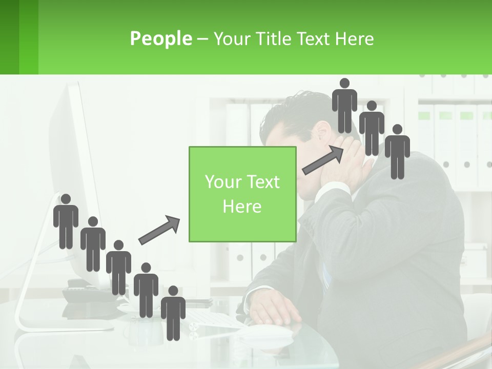 A Man Sitting At A Desk In Front Of A Computer PowerPoint Template