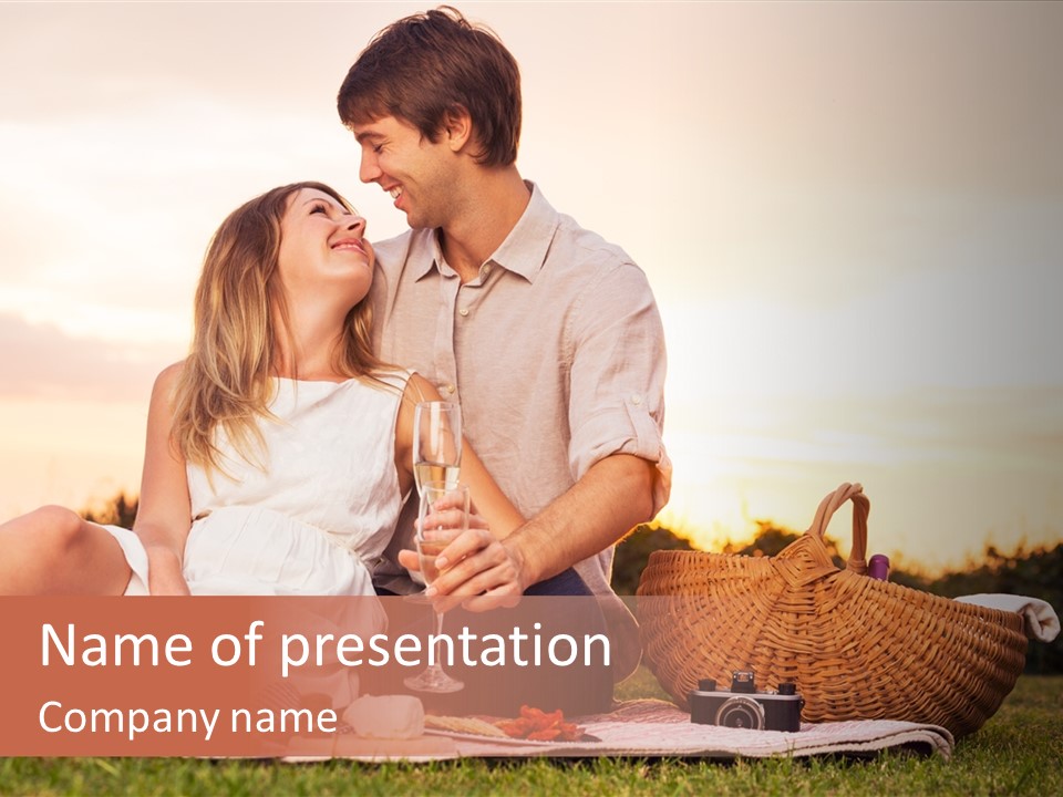 A Man And A Woman Sitting On A Blanket With A Bottle Of Champagne PowerPoint Template