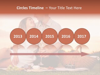 A Man And A Woman Sitting On A Blanket With A Bottle Of Champagne PowerPoint Template